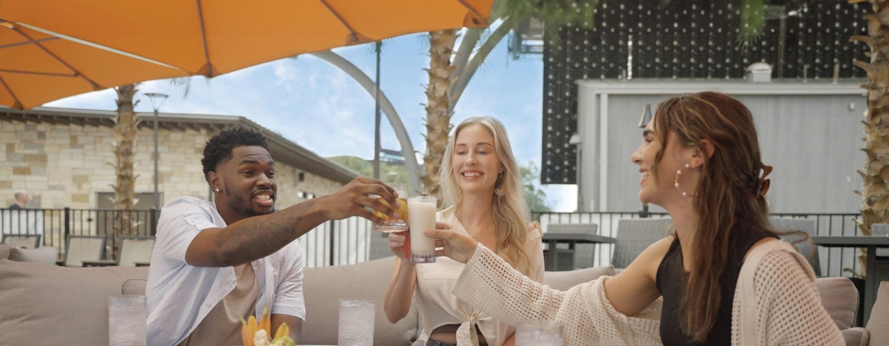 a group of people sitting at a table with drinks