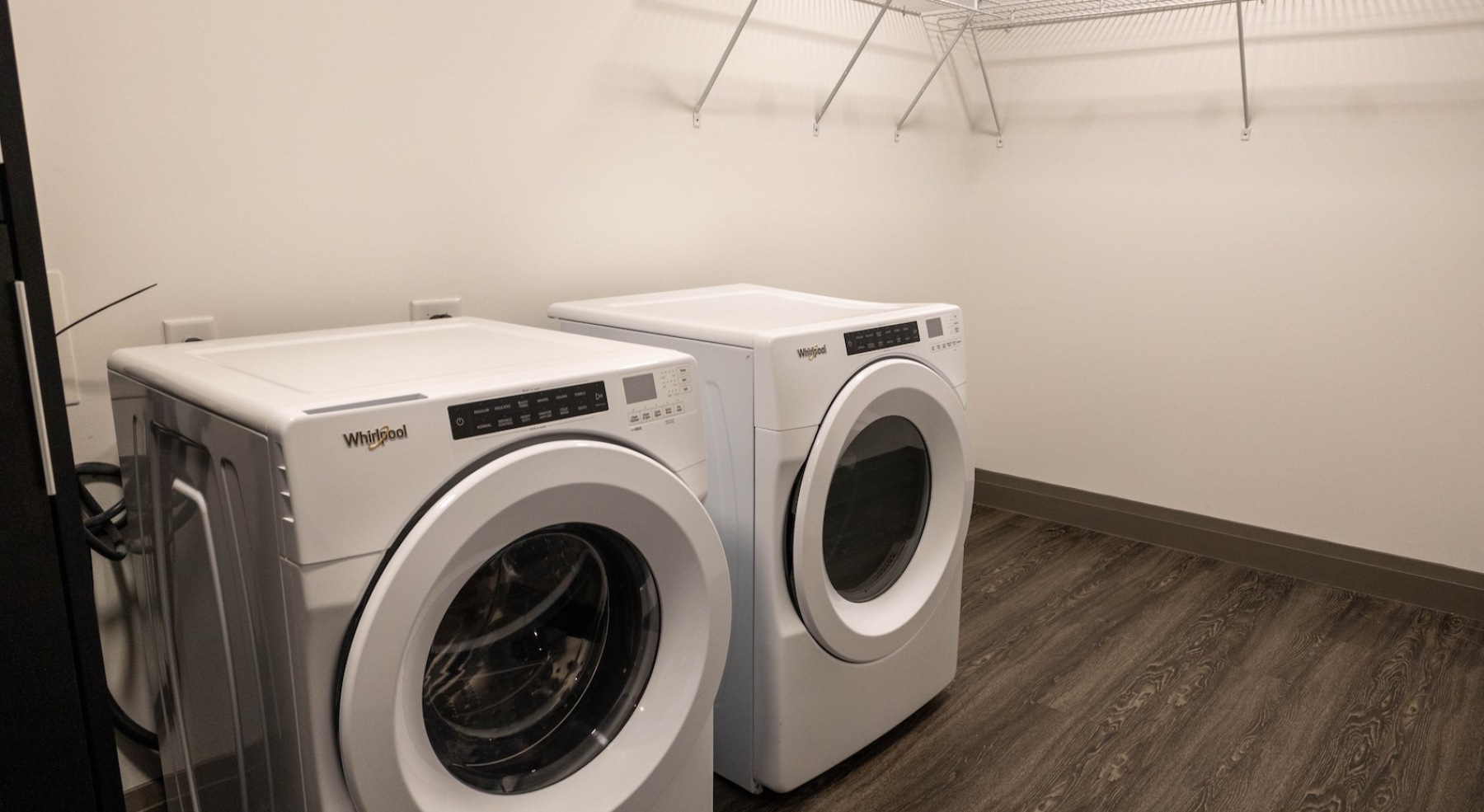 a large laundry room with ample shelving