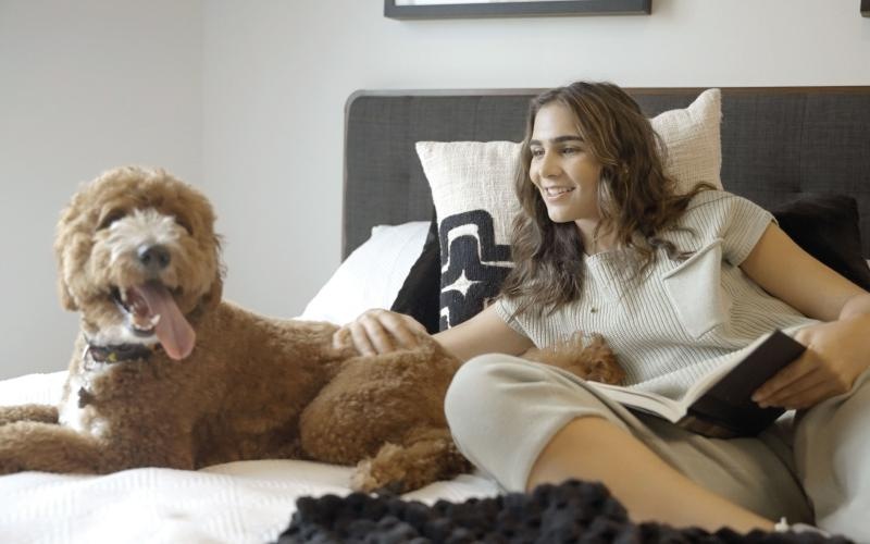 a person and a dog sitting on a couch