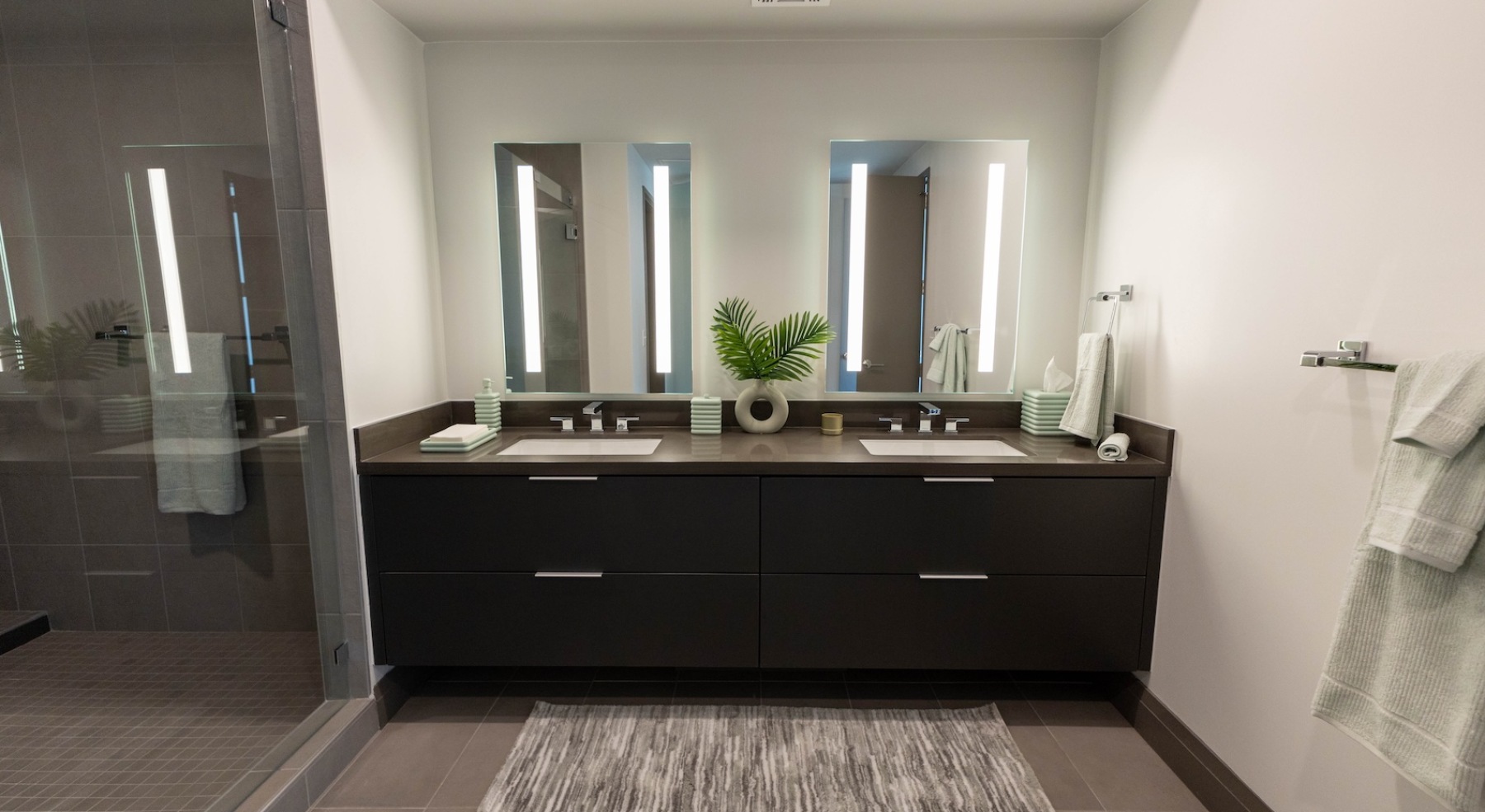 a spacious bathroom and double vanities